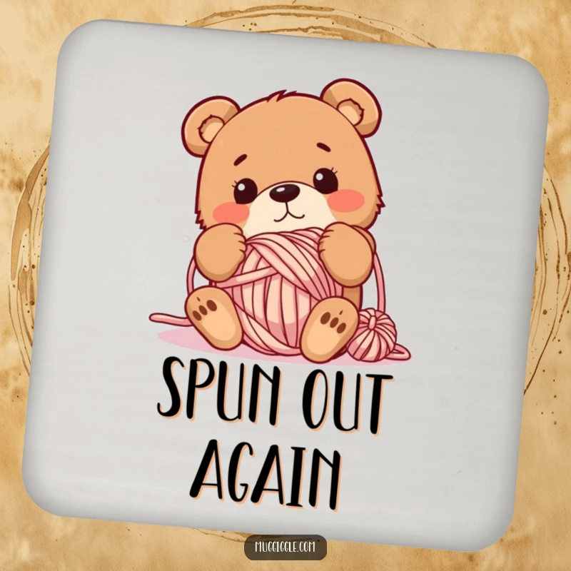 Funny coaster featuring a bewildered bear tangled in a yarn ball, adding whimsical flair and surface protection to tables.