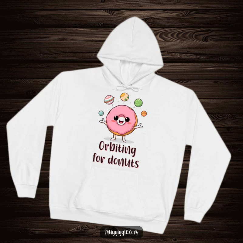 Funny donut character juggling small planets, radiating joy and humor in a cozy hoodie.