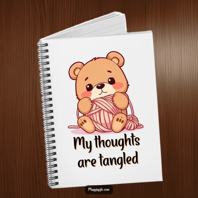 Funny notebook featuring a bewildered bear tangled in a ball of yarn, designed for jotting down creative ideas and crafting notes.
