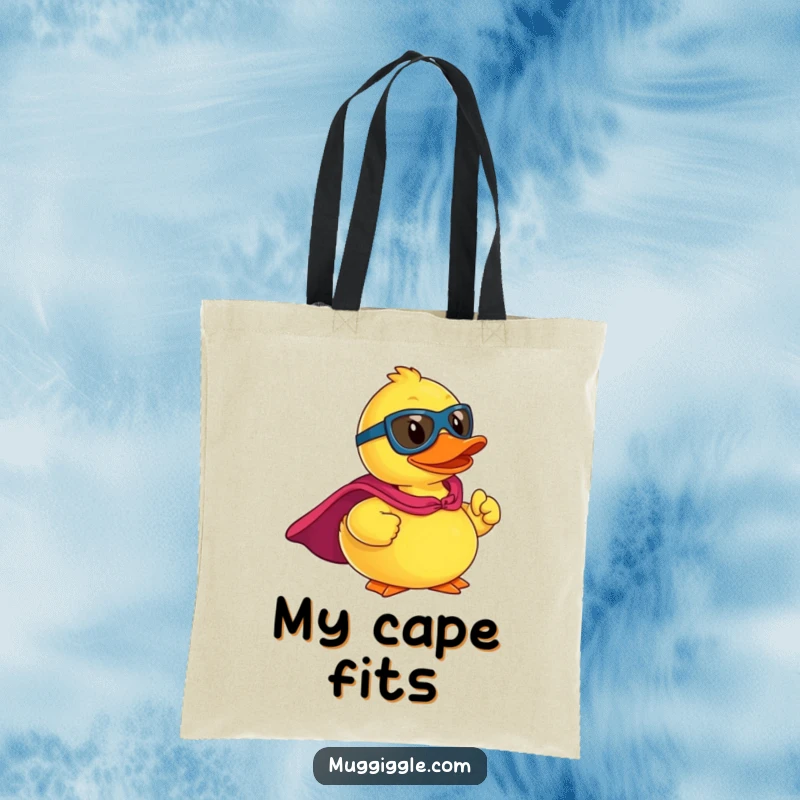 Funny tote bag showcasing a rubber ducky superhero in a cape, striking a powerful, heroic pose, ready to conquer.